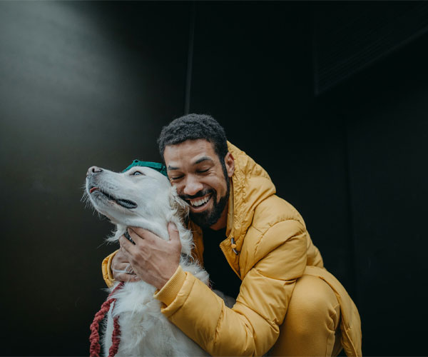 An Owner hugging his dog